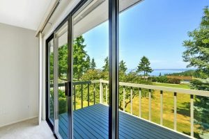 House with water view. Walkout deck with glass slide door